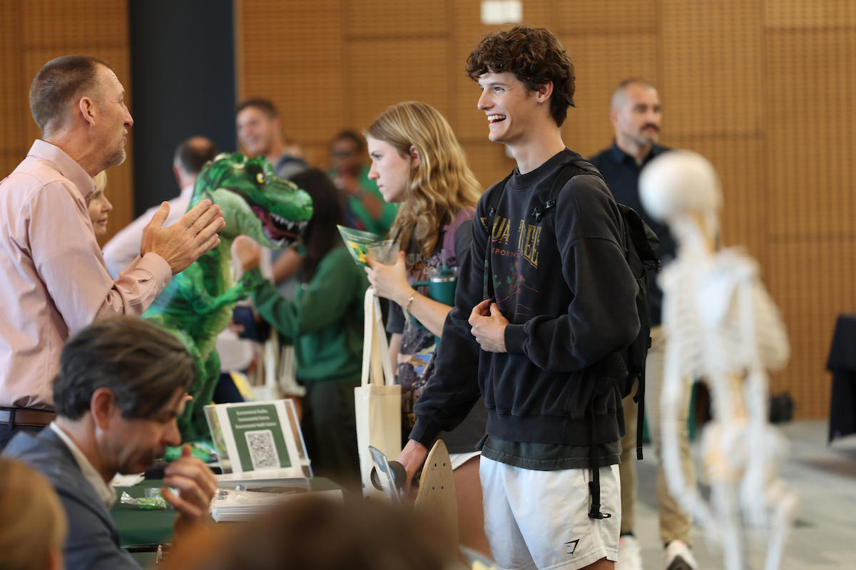 student speaking with faculty